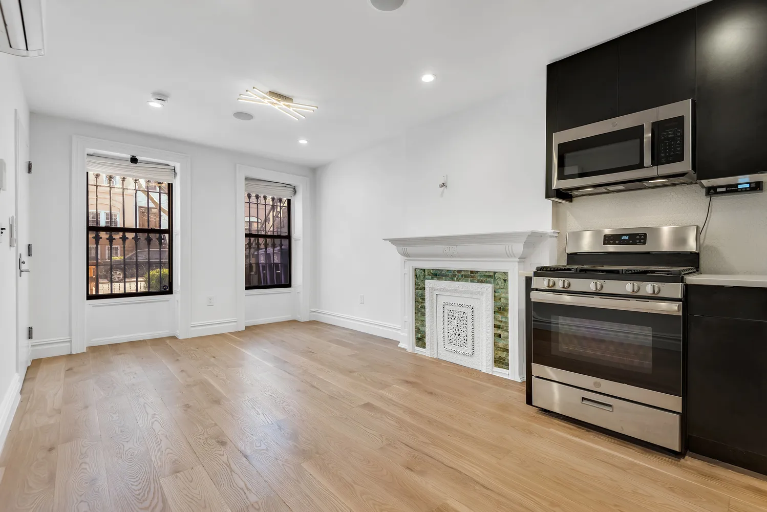 a view of kitchen with microwave stove and refrigerator