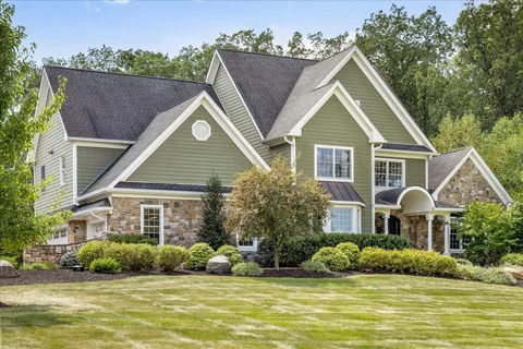a front view of house with yard and green space