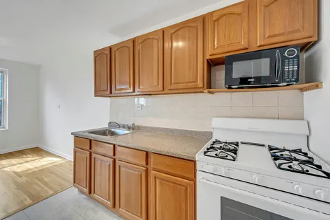 a kitchen with stainless steel appliances granite countertop a stove and a microwave
