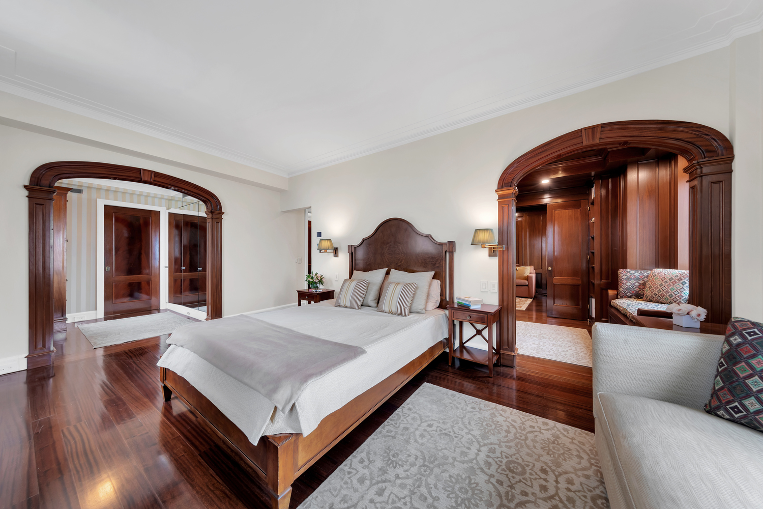 25 Central Park West, Unit 21J Manhattan, NY 10023 - Photo 23 of 37 a living room with a bed and dresser with wooden floor