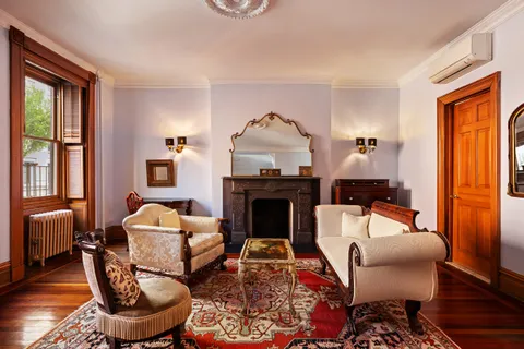 a living room with furniture a fireplace and a window