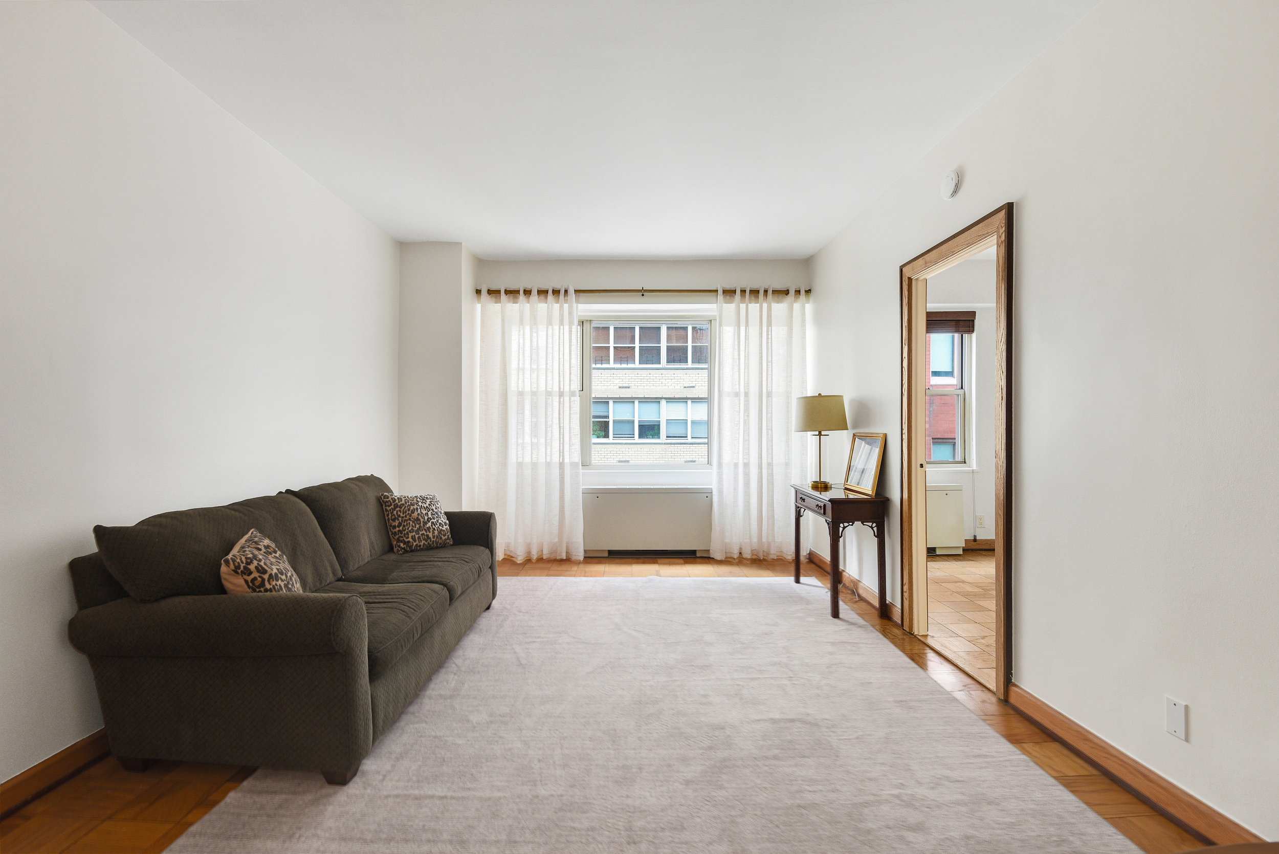 520 East 72nd Street, Unit 10P Manhattan, NY 10021 - Photo 4 of 13 a living room with furniture and a window