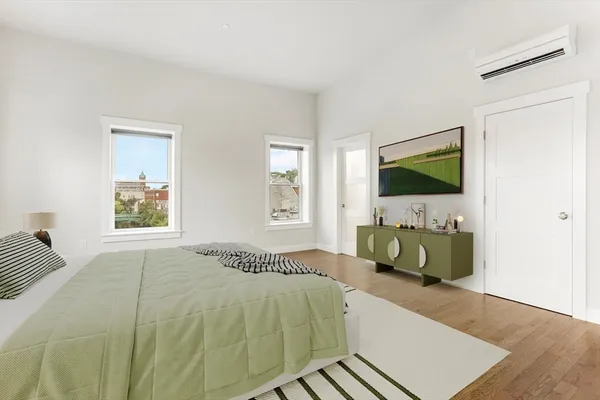 a bedroom with a bed and a flat screen tv