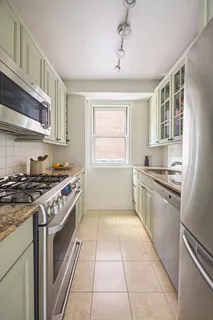a kitchen with a stove top oven sink and cabinets