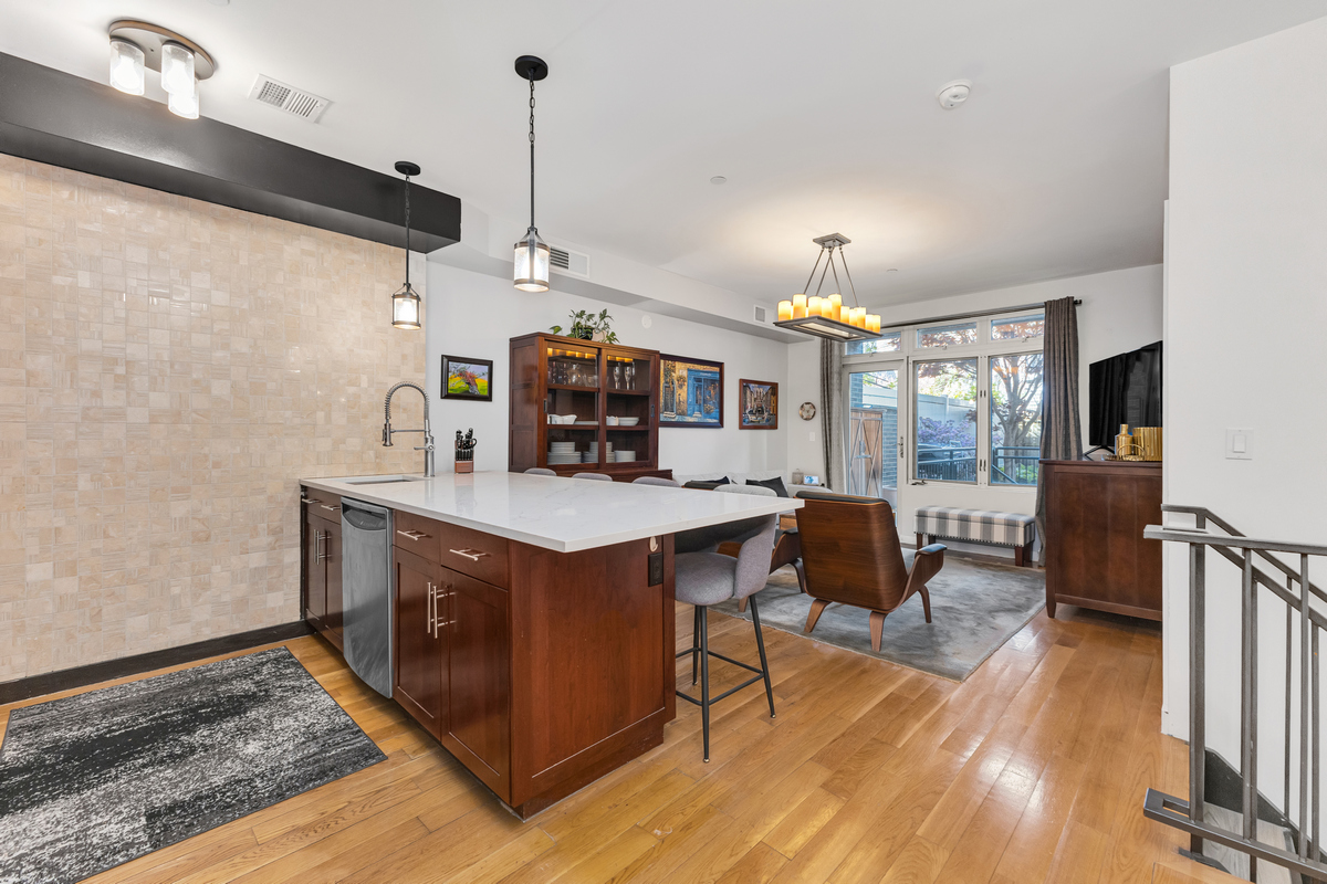 319 Humboldt Street, Unit 1B Brooklyn, NY 11211 - Photo 6 of 17 a view of living room with kitchen island furniture and a chandelier