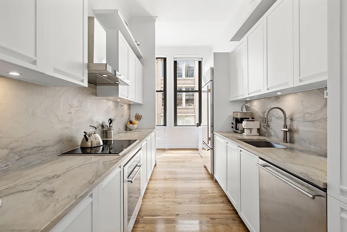 655 6th Avenue, Unit 5E Manhattan, NY 10010 - Photo 5 of 15 a kitchen with granite countertop a sink and cabinets