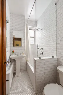 a bathroom with a sink toilet tub and mirror