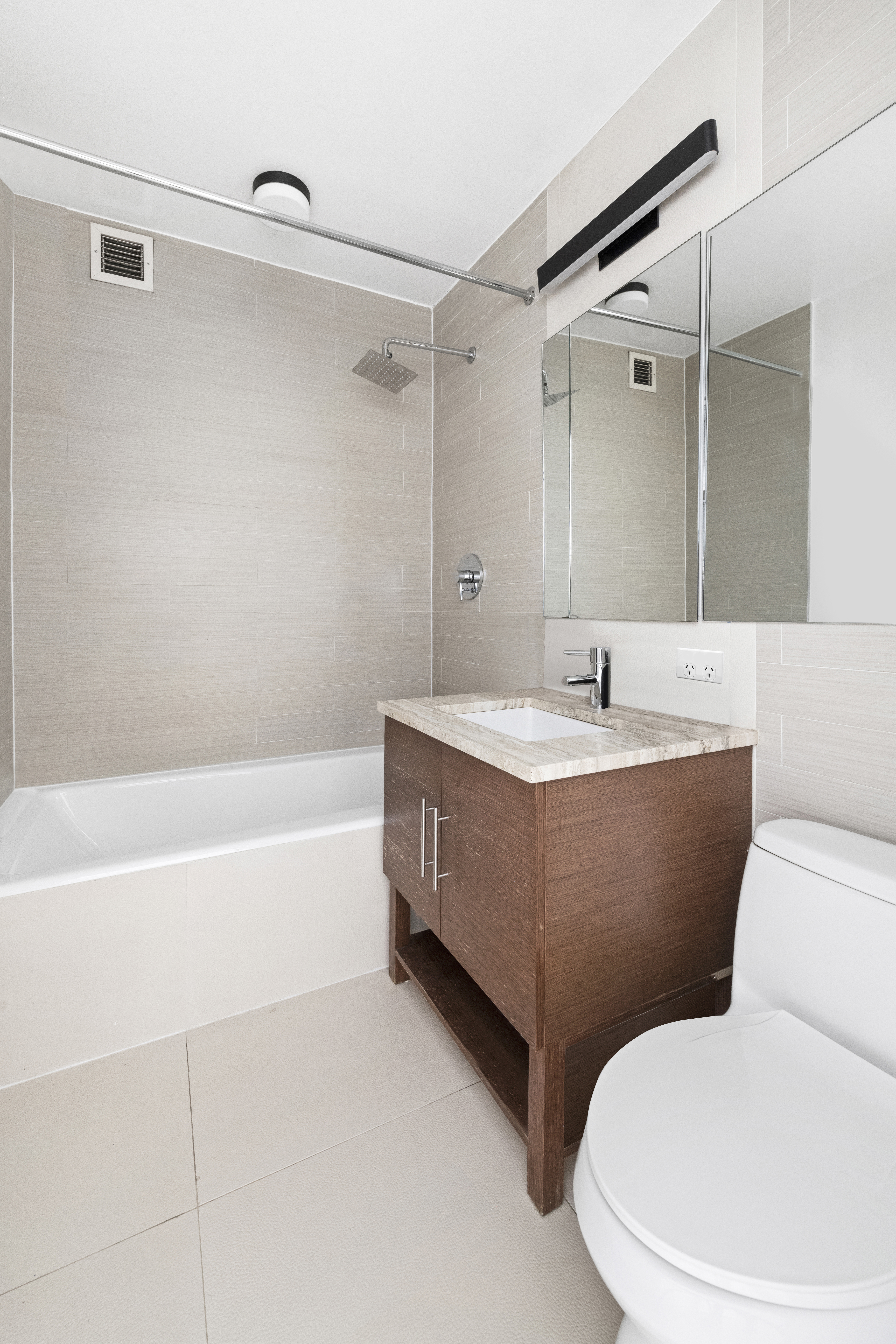 505 West 47th Street, Unit 2BS Manhattan, NY 10036 - Photo 3 of 5 a bathroom with a sink mirror toilet and bathtub