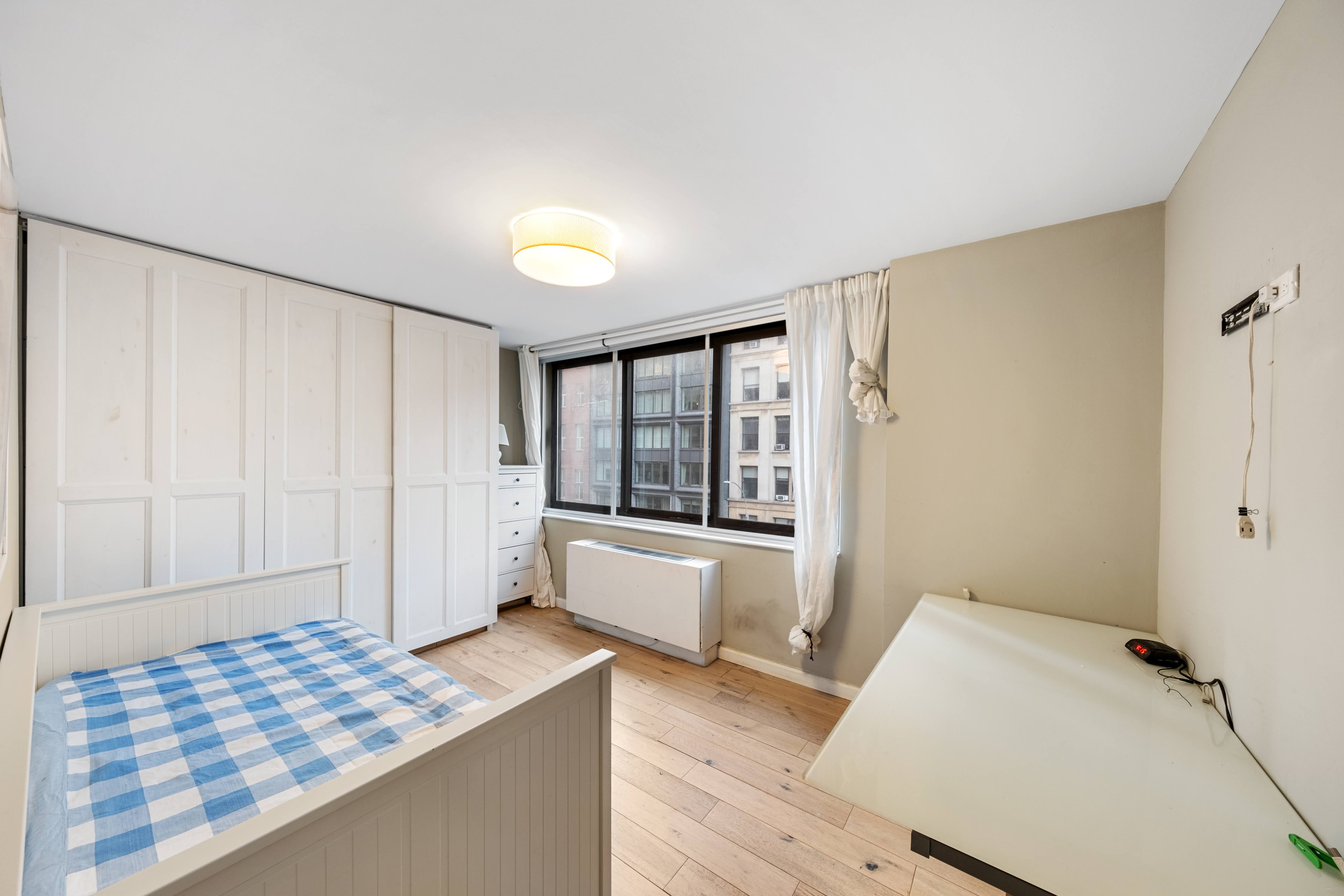 376 Broadway, Unit 4F Manhattan, NY 10013 - Photo 5 of 16 a bedroom with a bed and wooden floor