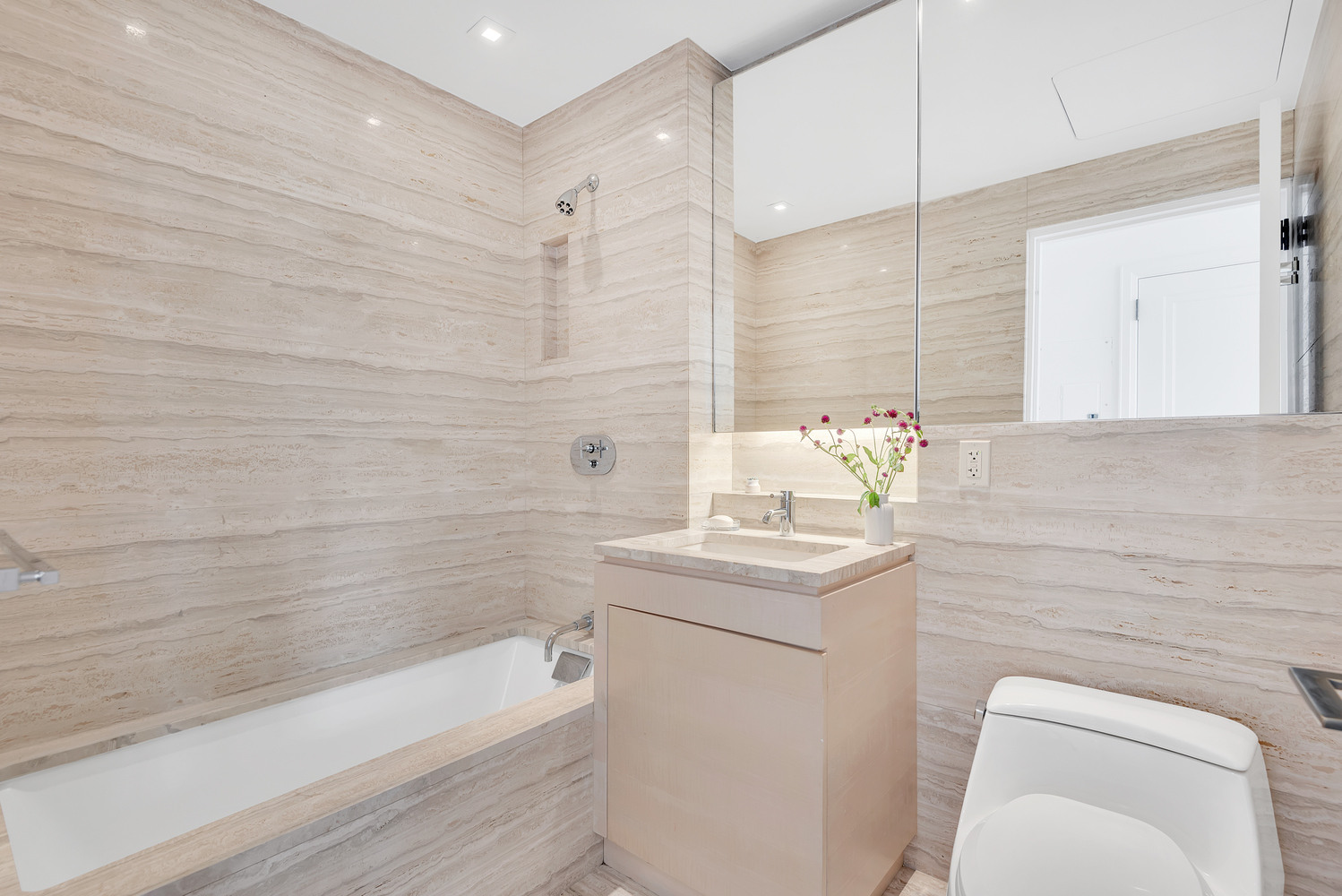 170 East End Avenue, Unit 16B Manhattan, NY 10128 - Photo 12 of 21 a bathroom with a sink a toilet and bathtub