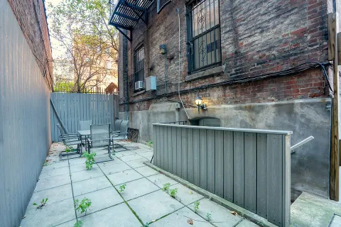 a view of balcony with chairs and wooden fence