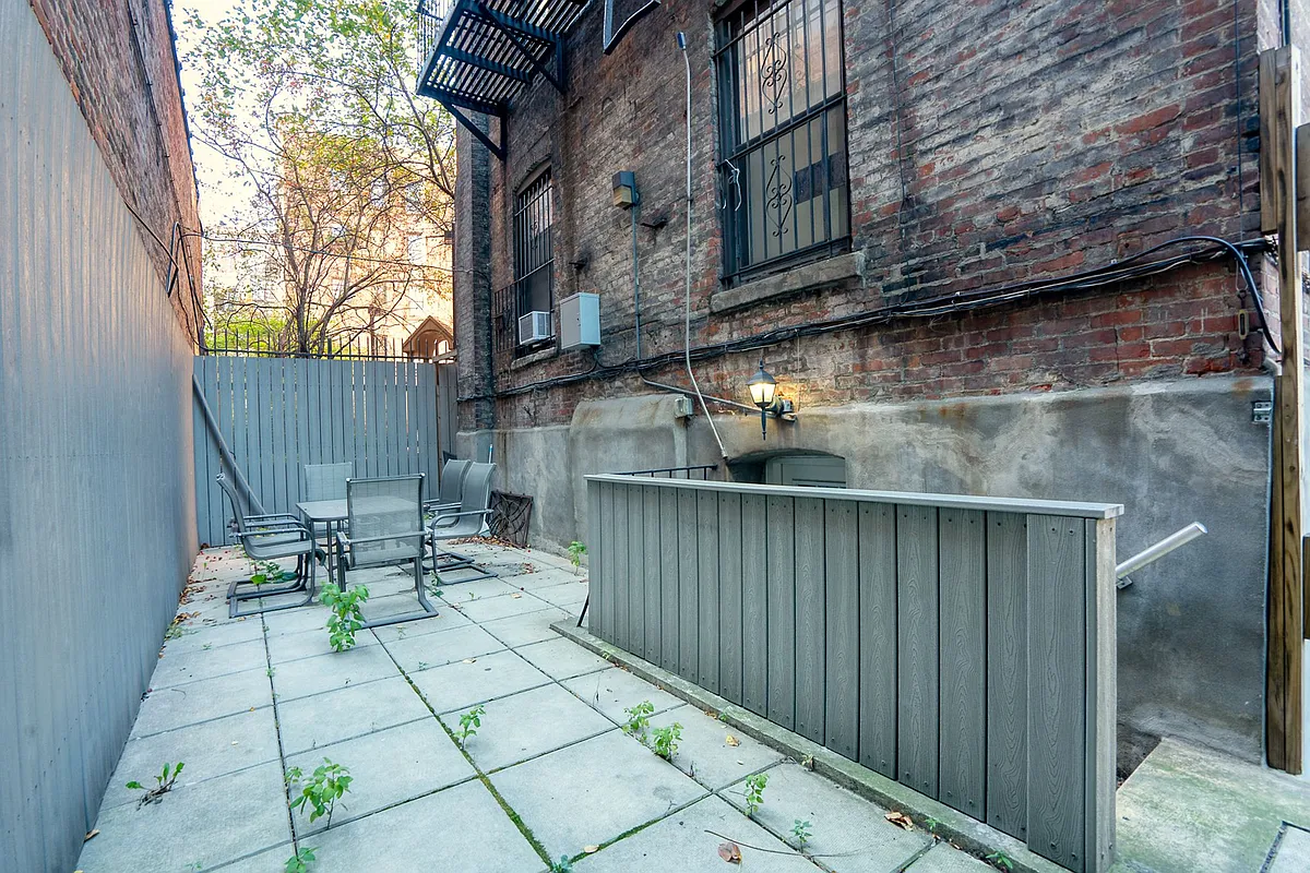150 West 84th Street, Unit 1B Manhattan, NY 10024 - Photo 8 of 10 a view of balcony with chairs and wooden fence