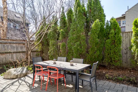 a backyard of a house with table and chairs
