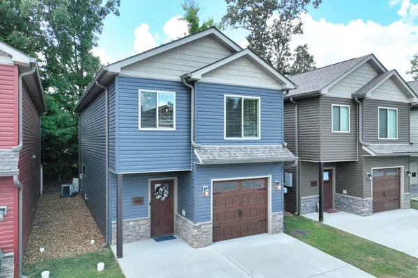 a front view of a house with a yard and garage