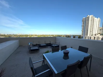 a view of a city from a dining room with furniture