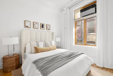 a bedroom with a bed and a window