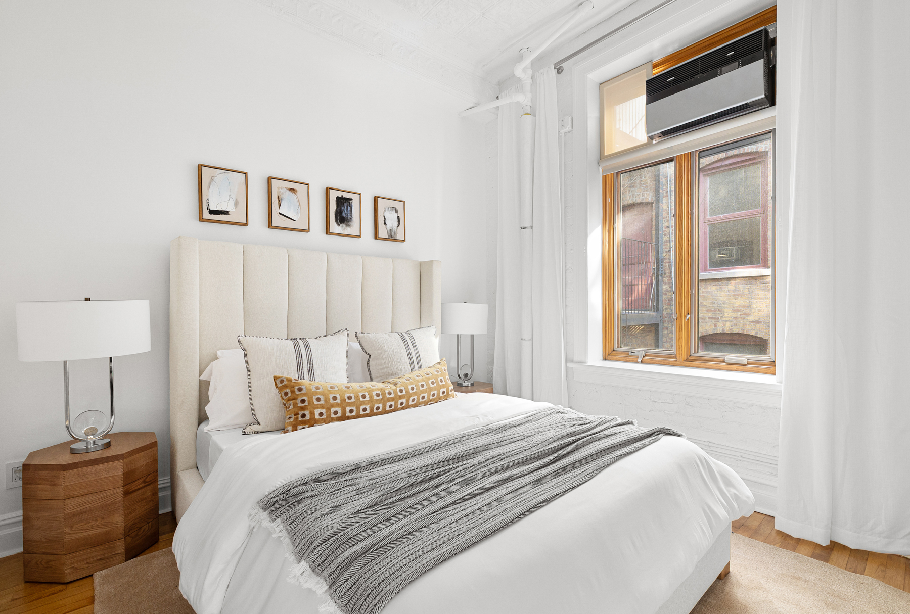 107 West 25th Street, Unit 5B Manhattan, NY 10001 - Photo 6 of 16 a bedroom with a bed and a window