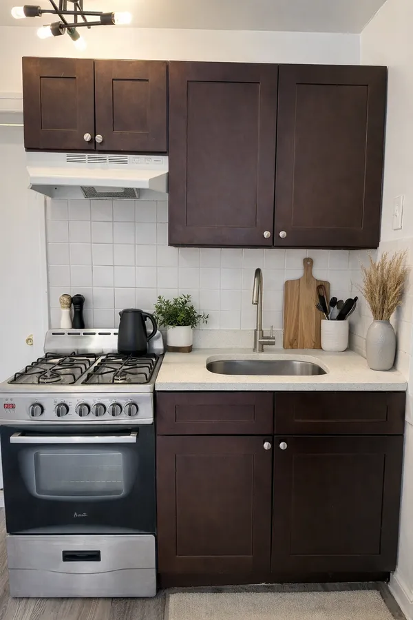 a kitchen with stainless steel appliances wooden cabinets and a sink