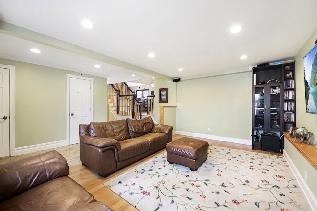2310 East 66th Street Brooklyn, NY 11234 - Photo 7 of 24 a living room with furniture a flat screen tv and rug