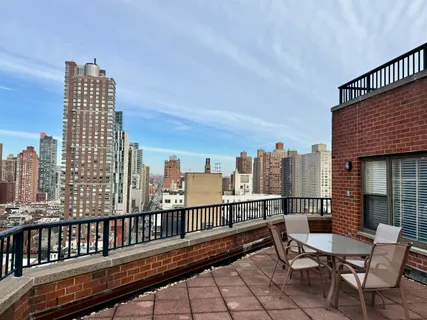 a view of a balcony with wooden benches