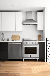 a kitchen with a stove a sink and a microwave