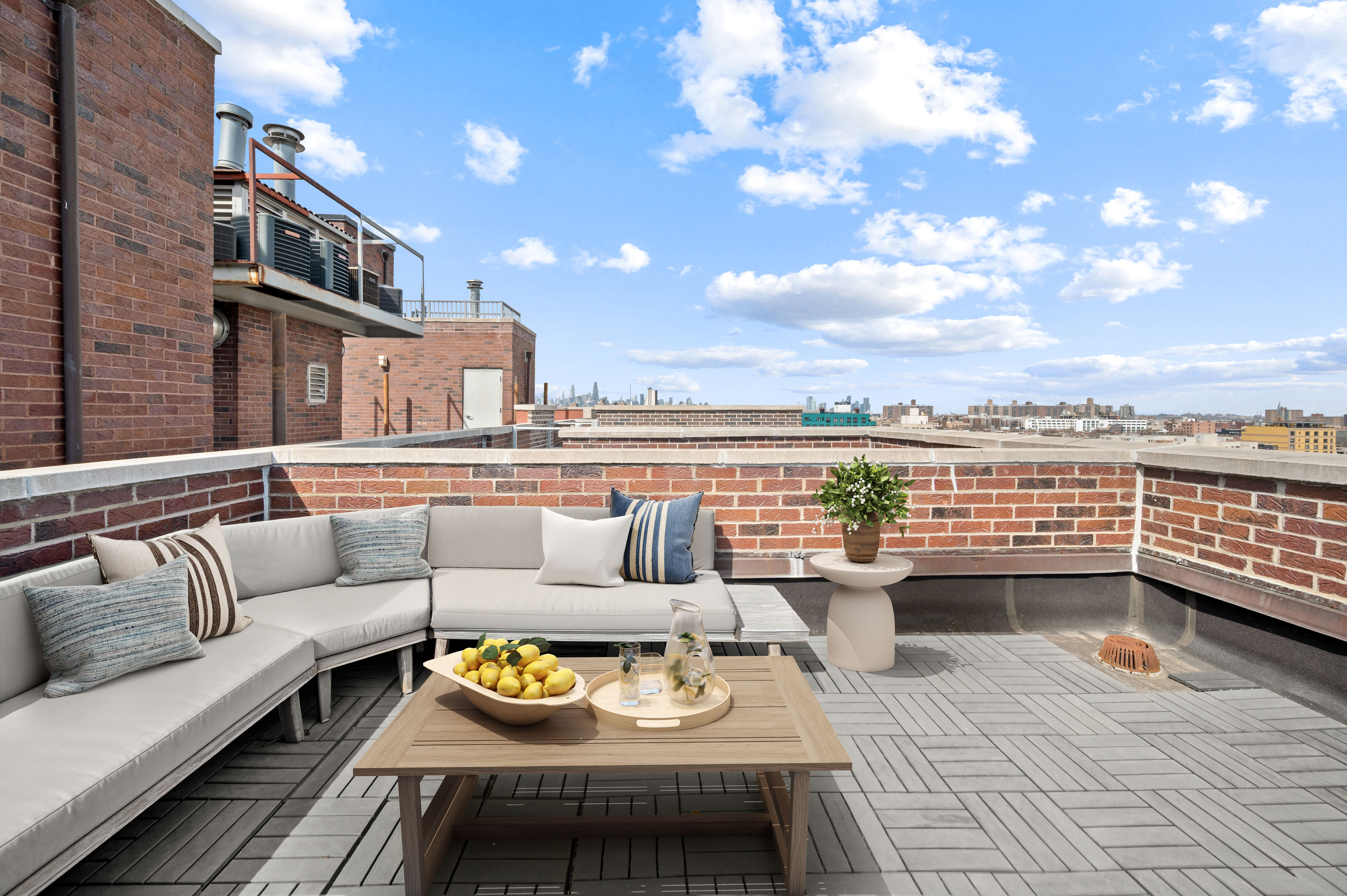 195 Spencer Street, Unit 9A Brooklyn, NY 11205 - Photo 7 of 8 a view of a roof deck with couches and potted plants