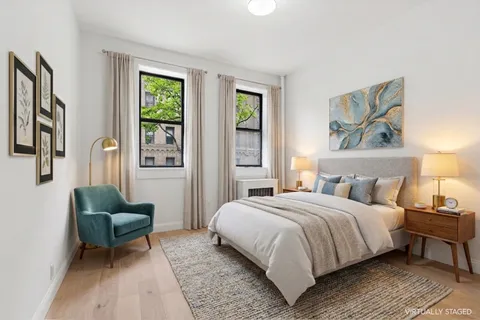a bedroom with a bed and a couch