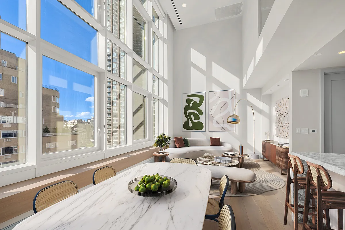 1059 3rd Avenue, Unit 10C Manhattan, NY 10065 - Photo 2 of 7 a living room with furniture and a potted plant