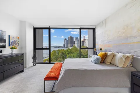 a bedroom with a bed and large window