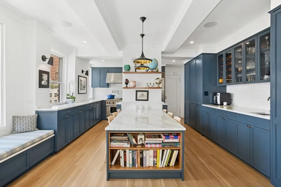 a large kitchen with stainless steel appliances granite countertop a stove and cabinets