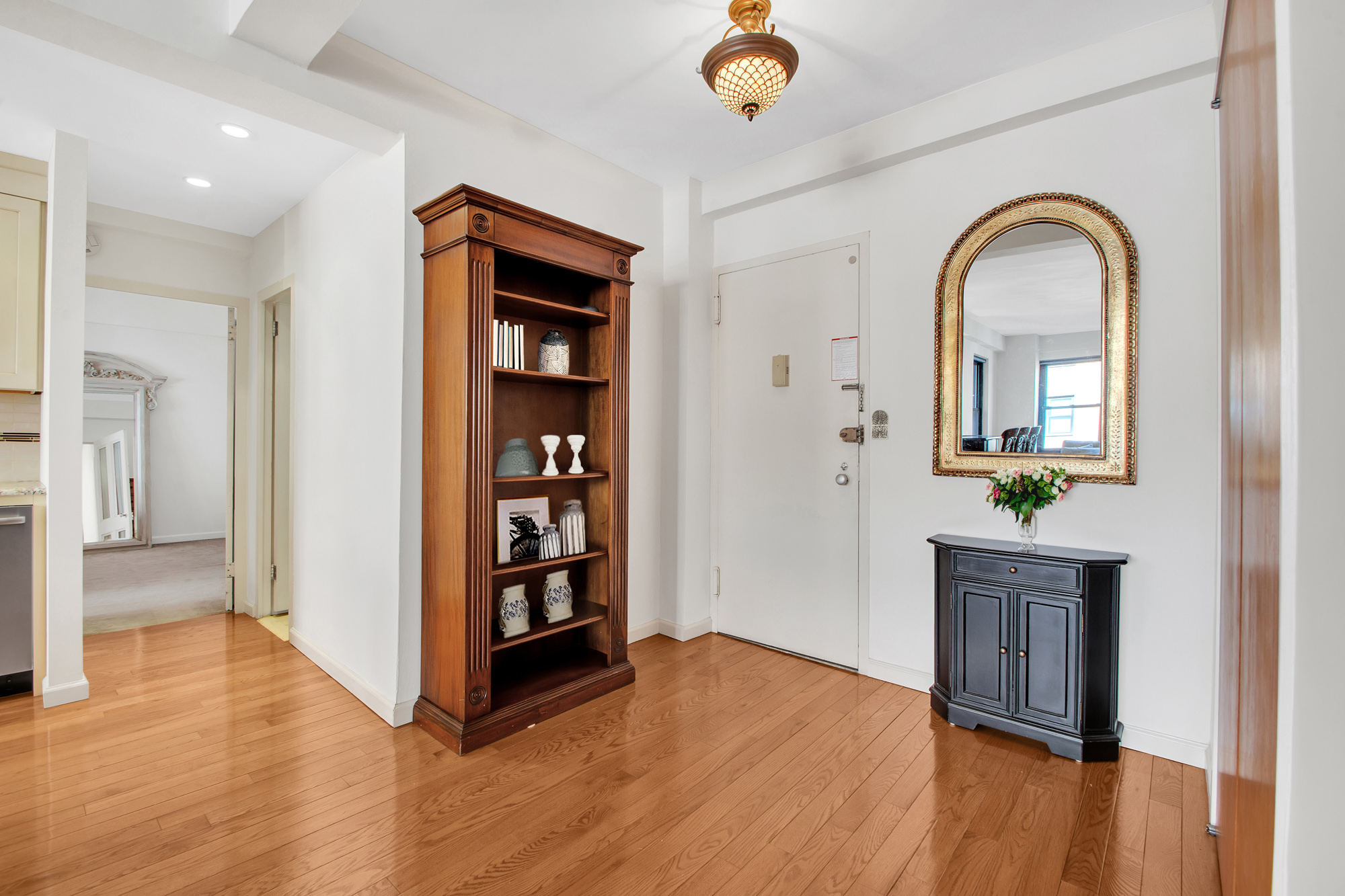 2 Tudor City Place, Unit 7FS Manhattan, NY 10017 - Photo 4 of 9 a view of a hallway to room with wooden floor and cabinet