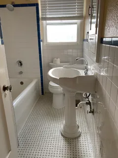 a bathroom with a sink a toilet and bathtub