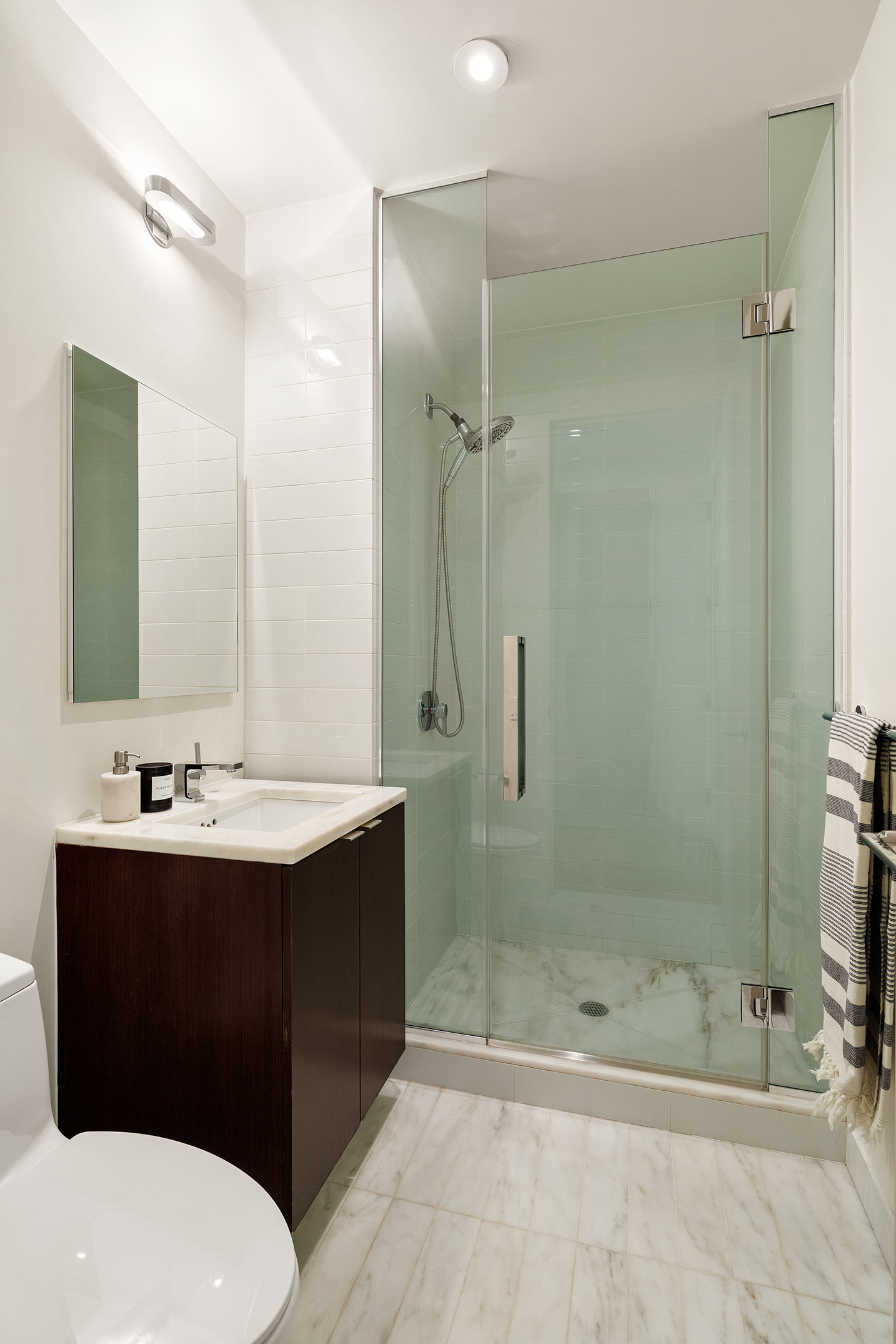 101 Warren Street, Unit 2010 Manhattan, NY 10007 - Photo 15 of 18 a bathroom with a sink a toilet and shower