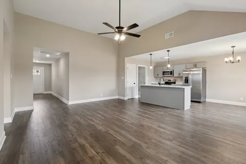a view of a kitchen with a sink and a stove top oven