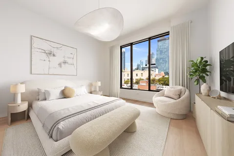 a spacious bedroom with a bed and a large window