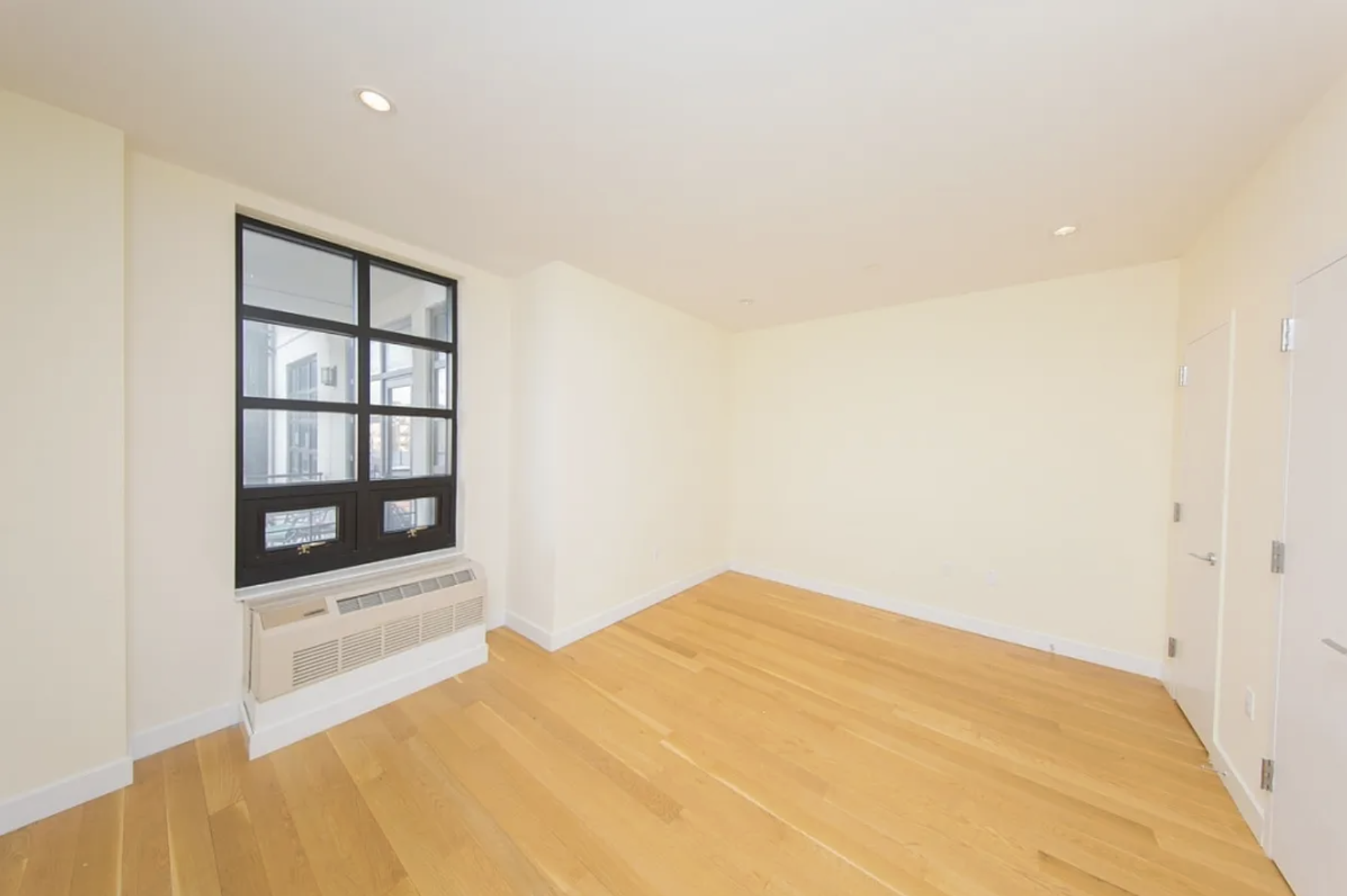 65 North 6th Street, Unit 5B Brooklyn, NY 11249 - Photo 5 of 5 a bedroom with a bed and a large window