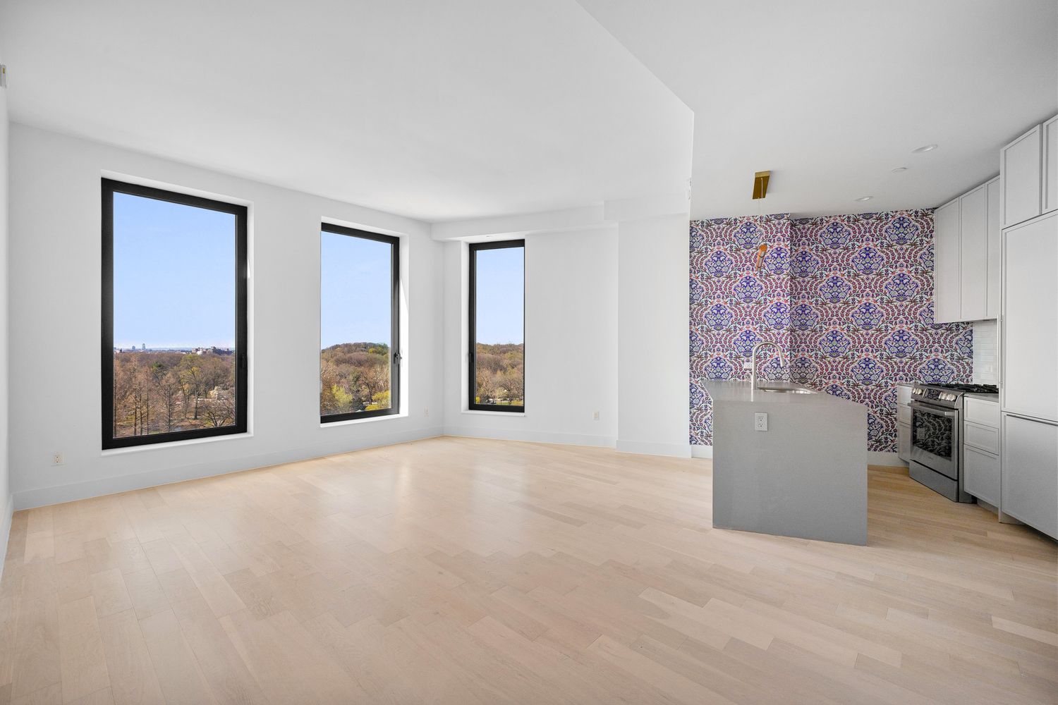 an empty room with furniture and windows