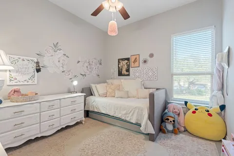 a bedroom with bed and window