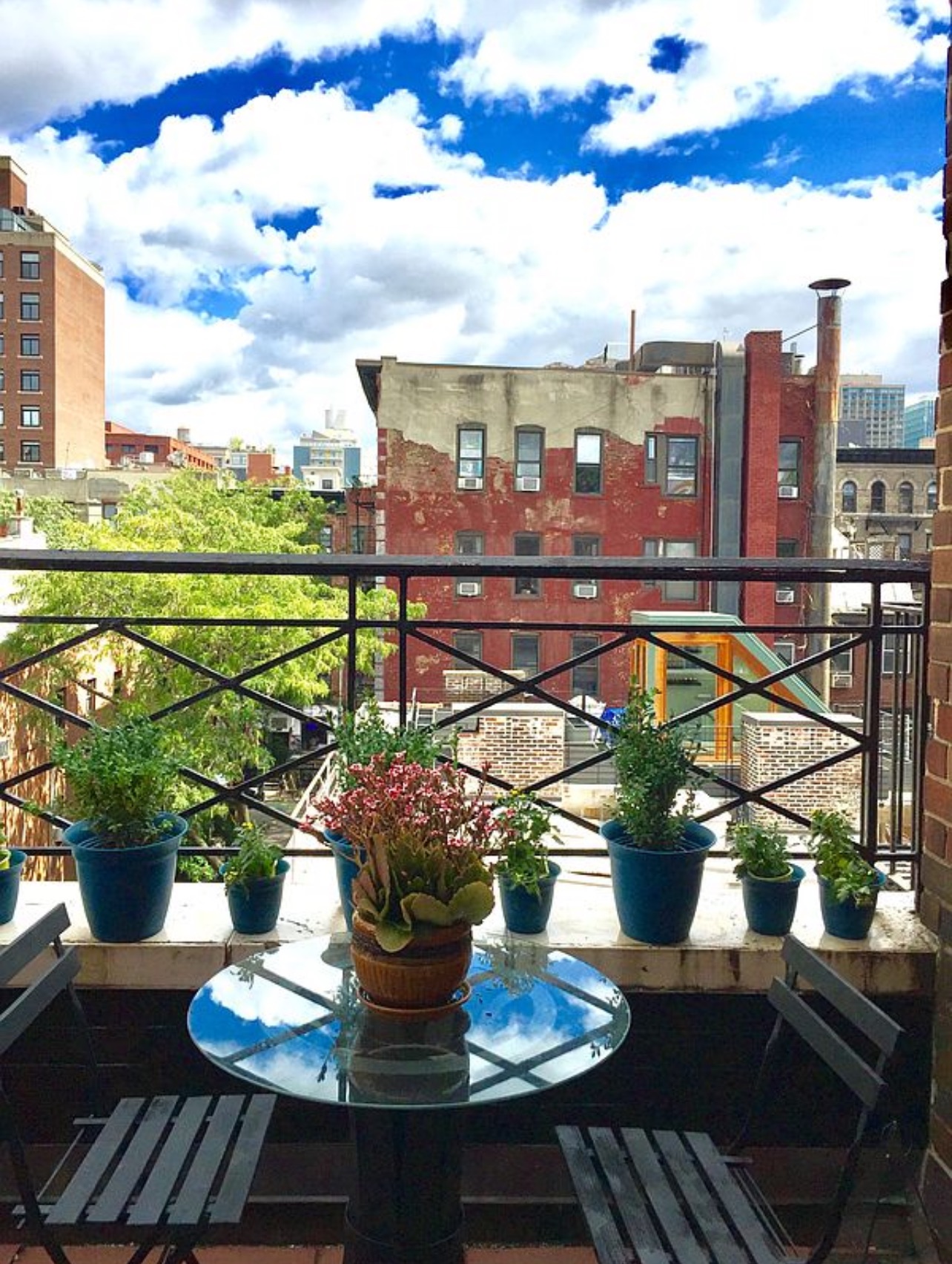 25 Minetta Lane, Unit 6G Manhattan, NY 10012 - Photo 5 of 13 a view of a balcony with chairs and a potted plant