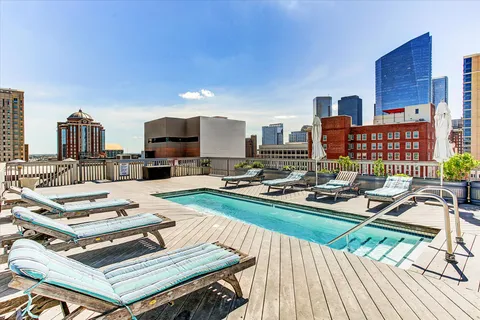 a living room with furniture and a book shelf
