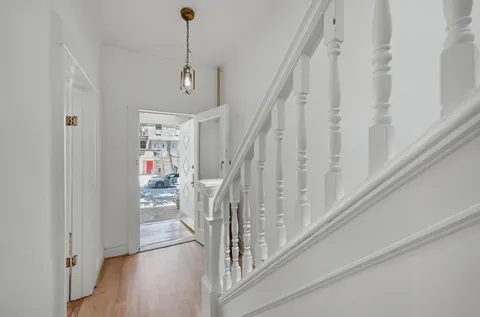 a view of entryway with stairs and wooden floor