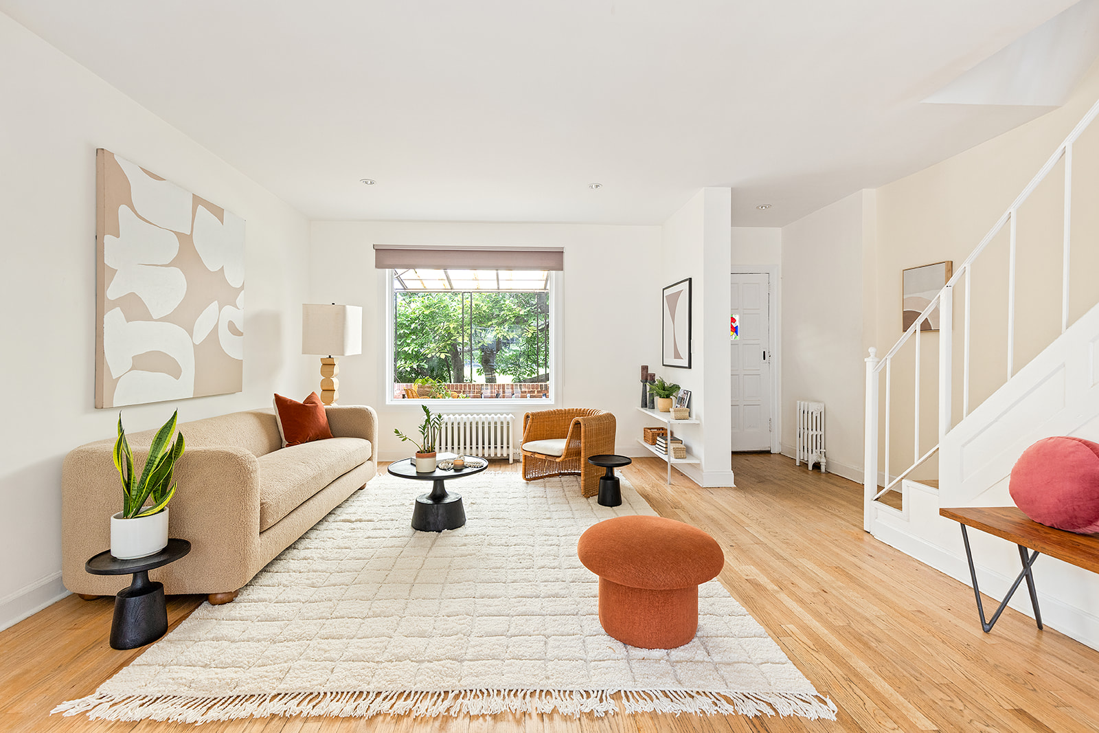 a living room with furniture and a potted plant