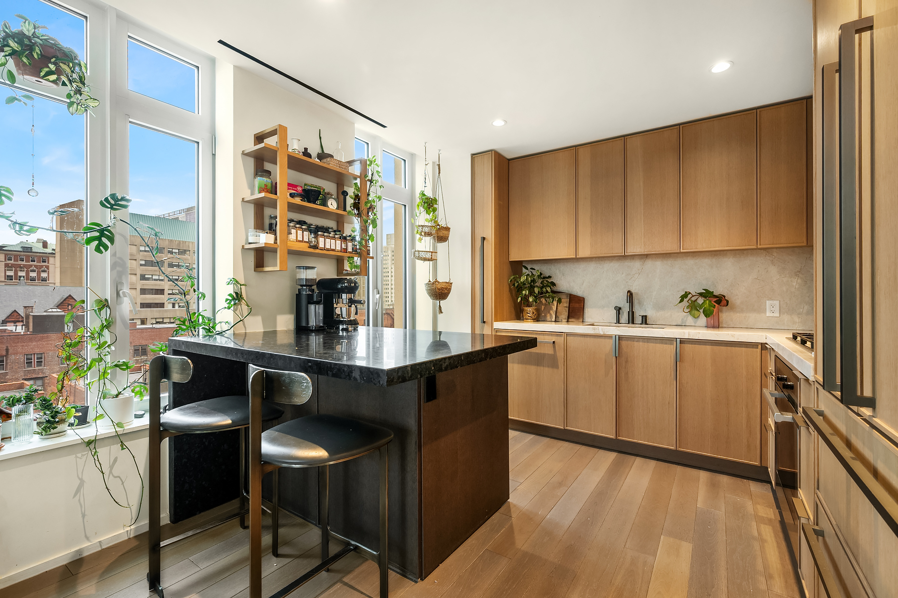 543 West 122nd Street, Unit 10E Manhattan, NY 10027 - Photo 7 of 12 a kitchen with a table chairs refrigerator and sink