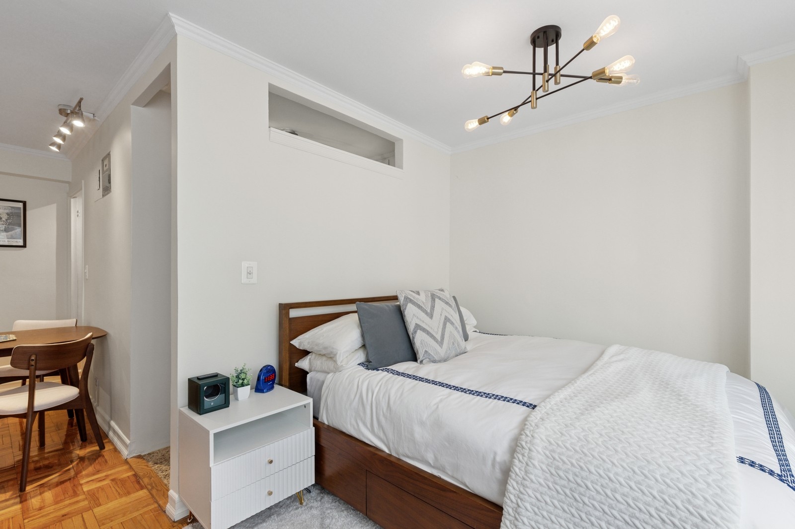 301 East 22nd Street, Unit 11U Manhattan, NY 10010 - Photo 2 of 11 a bedroom with a bed and a chandelier