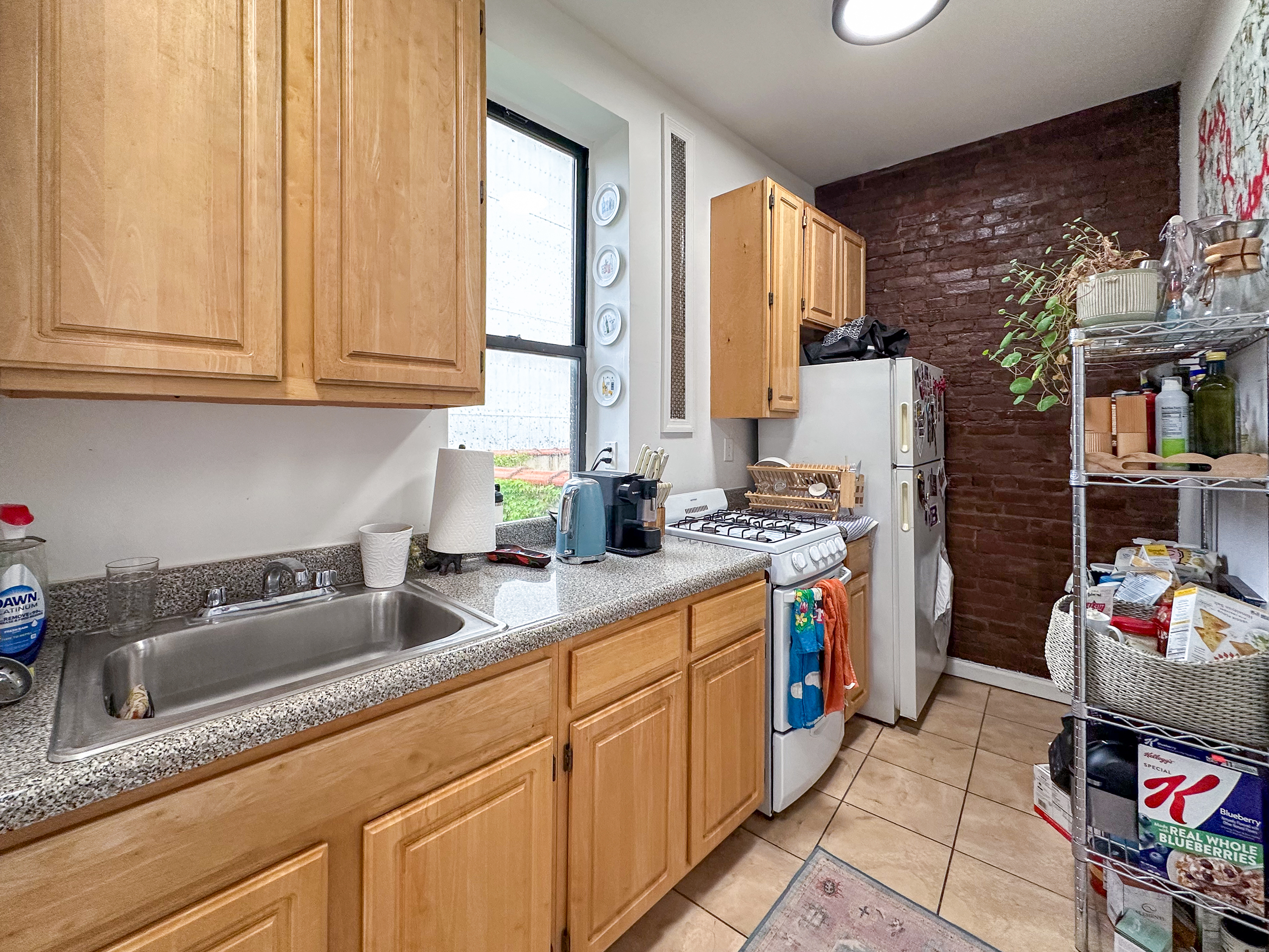 51 East 2nd Street, Unit 10 Manhattan, NY 10003 - Photo 3 of 16 a kitchen with stainless steel appliances granite countertop a sink stove and cabinets