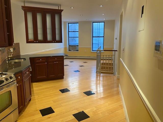 a kitchen with stainless steel appliances granite countertop a sink and a stove