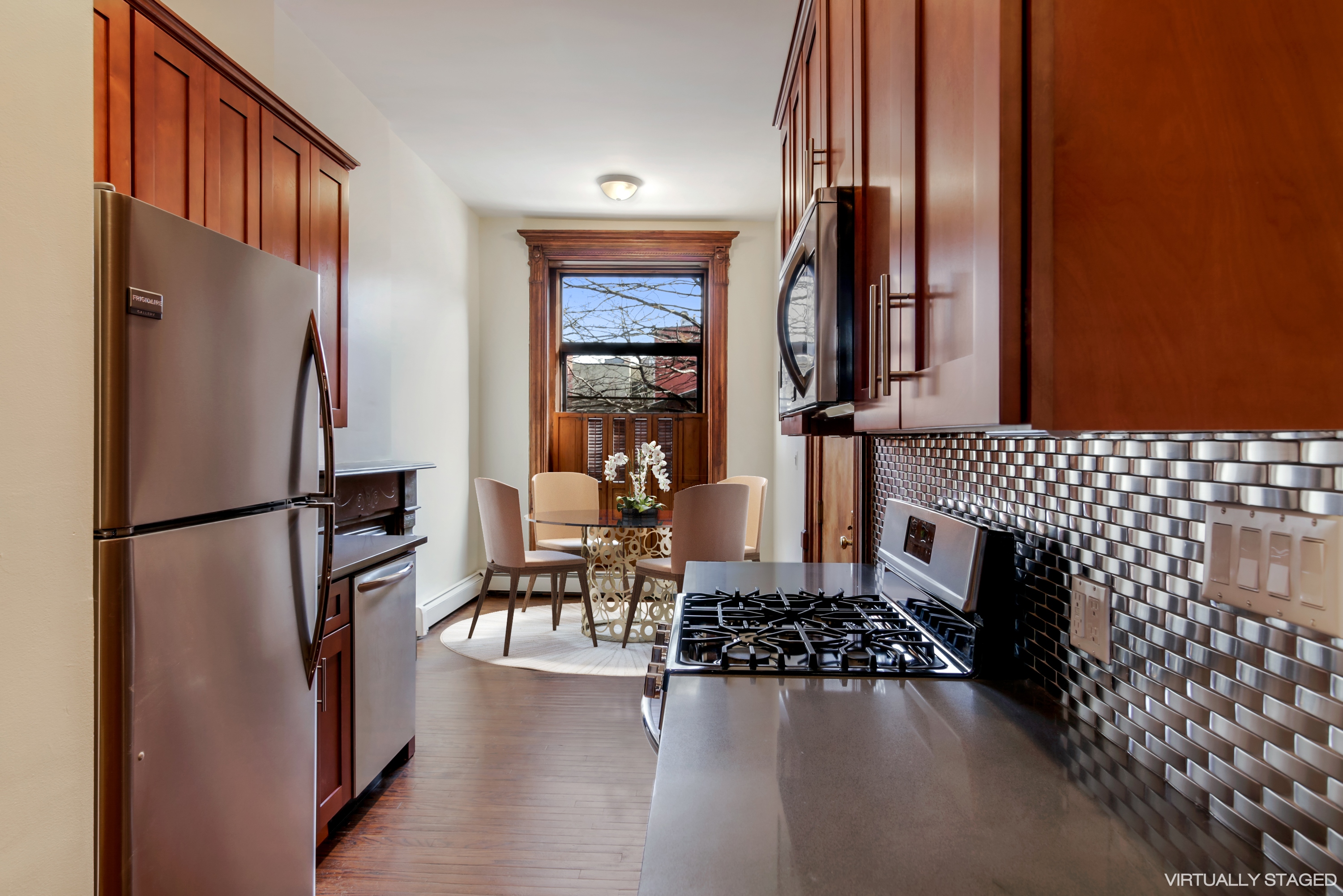 67 Gates Avenue, Unit 1 Brooklyn, NY 11238 - Photo 3 of 7 a kitchen with stainless steel appliances a refrigerator and a stove top oven
