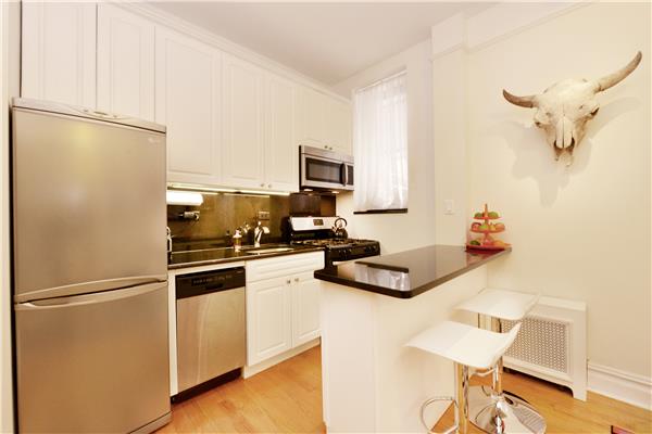 660 Riverside Drive, Unit 1B Manhattan, NY 10031 - Photo 2 of 5 a kitchen with a refrigerator and a stove top oven