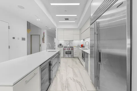 a kitchen with cabinets and wooden floors