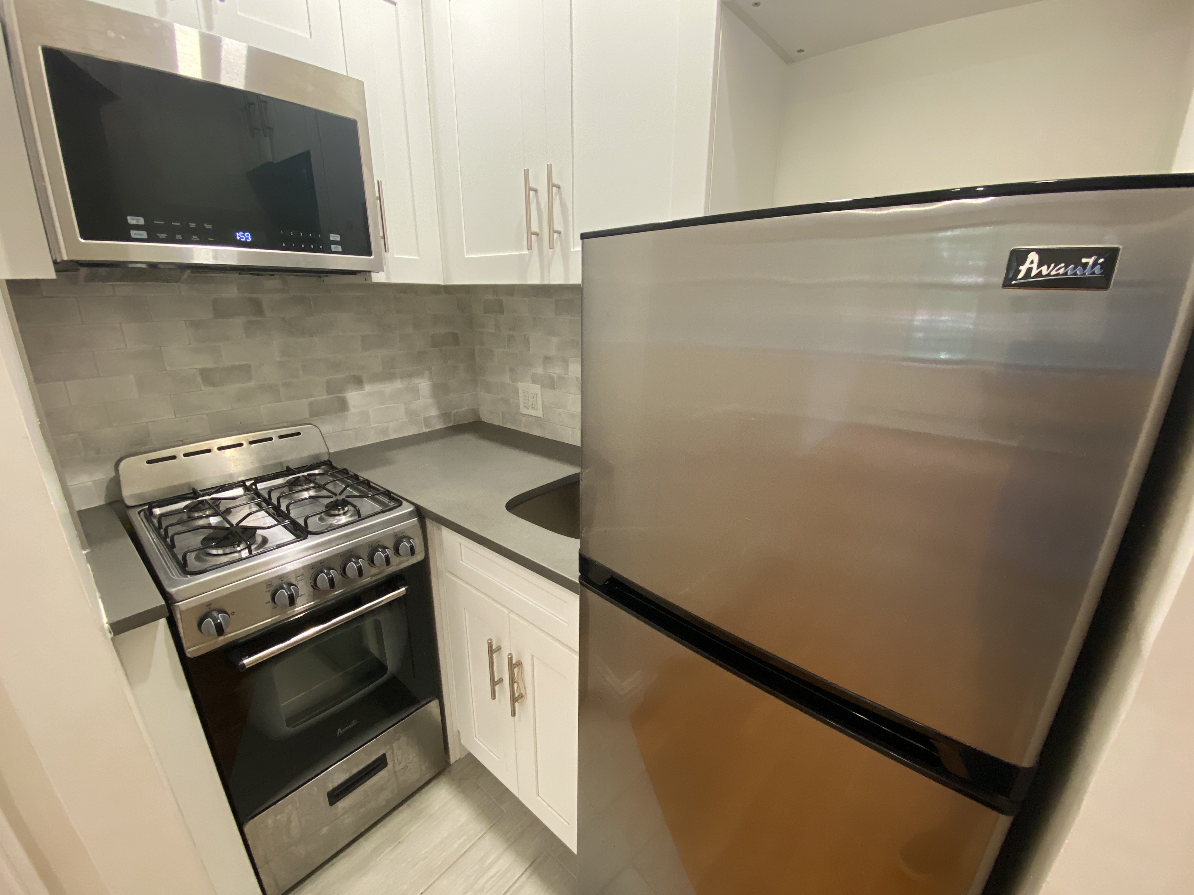 a kitchen with a stove and a microwave